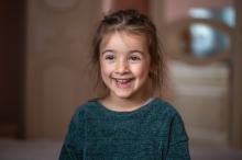 close-up-portrait-of-a-little-girl-in-her-room
