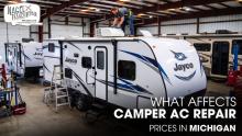 A Male Technician Repairing the AC Unit of a Jayco Camper inside a Workshop