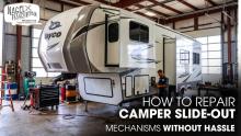 A Jayco 5th Wheel RV parked inside a Workshop for Slide-Out Repair works