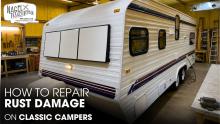 A Classic Camper Trailer parked inside a Workshop for Repair Works
