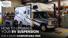 A Class C Motorhome Parked Inside a Workshop for Suspension Works
