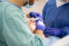 a dentist putting dental implants on a patient in Adelaide Australia