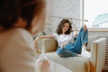 woman-in-white-shirt-sitting-on-couch