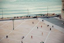 people-walking-on-spacious-city-square-on-waterfront