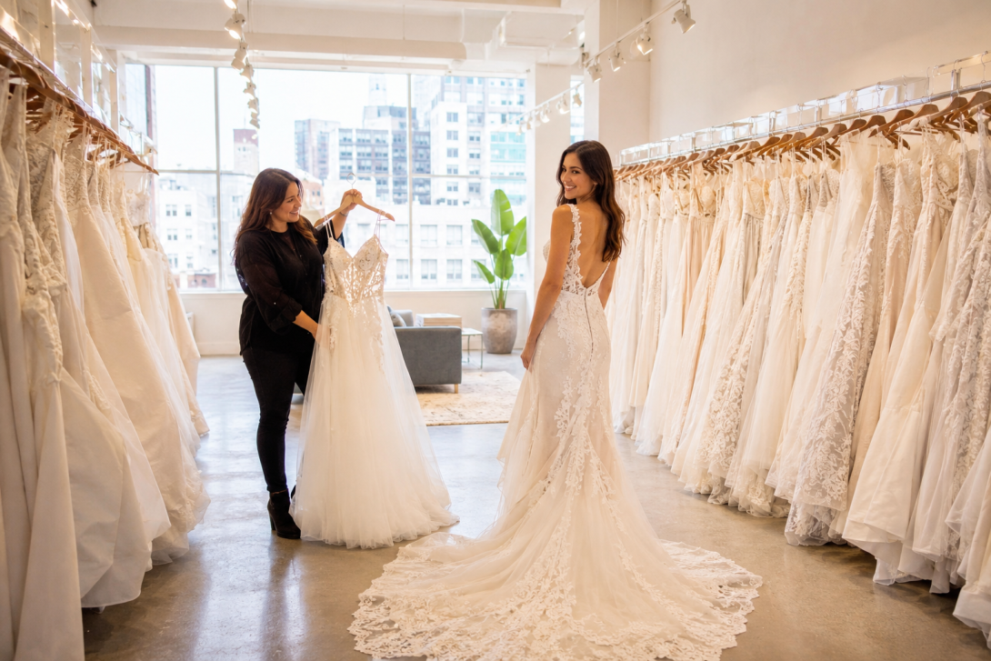 Bride exploring wedding gowns at a bridal shop near San Francisco California with a stylist