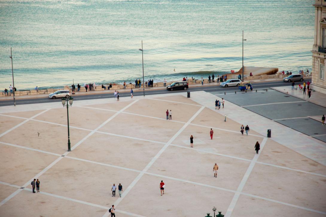 people-walking-on-spacious-city-square-on-waterfront