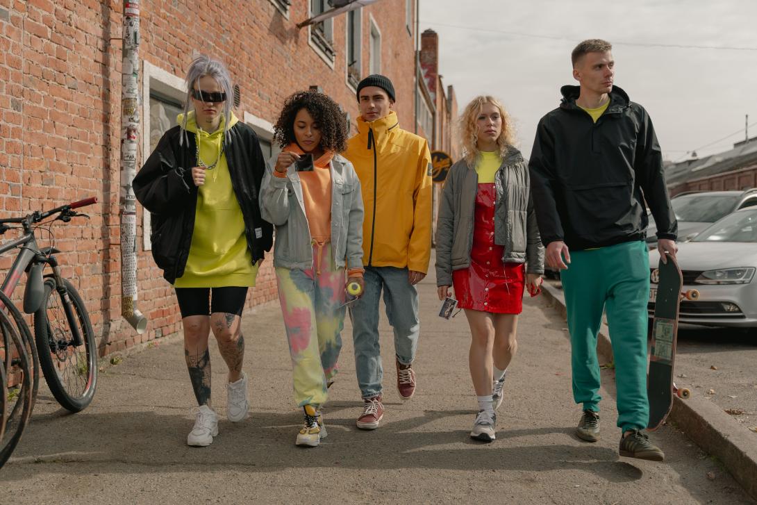 a-group-of-people-wearing-jackets-walking-together-on-pavement