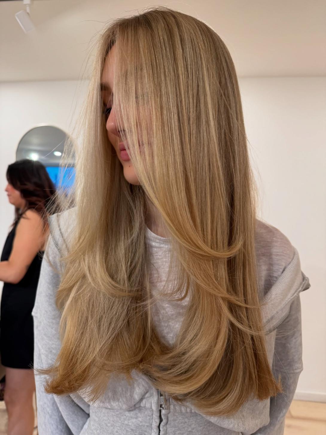 Professional hairstylist providing a stylish haircut and personalized hair care in an East Village salon.